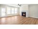 Spacious living room with hardwood floors, fireplace, and lots of natural light at 152 Palm St, Holly Springs, GA 30115