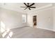 Bright main bedroom with carpet, ceiling fan and en-suite bathroom at 152 Palm St, Holly Springs, GA 30115
