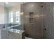 Modern shower with herringbone tile and built-in shelving at 152 Palm St, Holly Springs, GA 30115