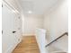 Upstairs hall with hardwood floors and access to bedrooms at 152 Palm St, Holly Springs, GA 30115