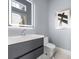 Modern bathroom with gray vanity, frameless mirror, and marble floor at 35 Robin Hood Ne Rd, Atlanta, GA 30309