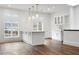 Modern white kitchen with island, quartz countertops, and pendant lighting at 35 Robin Hood Ne Rd, Atlanta, GA 30309