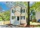 Two-story white house with black shutters, front porch, and landscaping at 2453 Paul Nw Ave, Atlanta, GA 30318