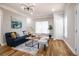 Bright living room with hardwood floors, comfortable seating and a stylish chandelier at 2453 Paul Nw Ave, Atlanta, GA 30318