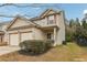 Two-story house with beige siding, brick accents, and a two-car garage at 6057 Hemperly Rd, Atlanta, GA 30349