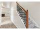 Gray carpeted staircase with wooden handrail and iron balusters at 6057 Hemperly Rd, Atlanta, GA 30349