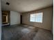 Spacious living room with neutral carpeting and large window at 2001 Chestnut Log Dr, Lithia Springs, GA 30122