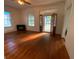 Spacious living room with hardwood floors and access to the front porch at 1123 Arlington Sw Ave, Atlanta, GA 30310