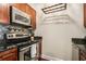 Well-equipped kitchen featuring stainless steel appliances and dark wood cabinets at 325 E Paces Ferry Rd # 1110, Atlanta, GA 30305