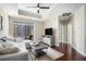 Bright living room with hardwood floors, sectional sofa, and access to balcony at 325 E Paces Ferry Rd # 1110, Atlanta, GA 30305