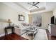 Spacious living room with hardwood floors, sectional sofa, and balcony access at 325 E Paces Ferry Rd # 1110, Atlanta, GA 30305