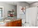 Bathroom with granite countertop, wood cabinets, and a shower at 943 Peachtree Ne St # 1708, Atlanta, GA 30309