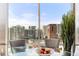 Bright dining room with city views and modern glass table at 943 Peachtree Ne St # 1708, Atlanta, GA 30309