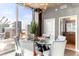 Modern dining room with city views and a glass dining table at 943 Peachtree Ne St # 1708, Atlanta, GA 30309