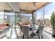 Elegant dining room with a glass table, city views, and modern chandelier at 943 Peachtree Ne St # 1708, Atlanta, GA 30309