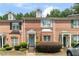 Brick townhouse exterior with landscaping and a gray door at 1968 Drennon Ave, Austell, GA 30106