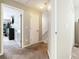 Upper hallway with neutral walls and carpet; access to bedrooms and closets at 1968 Drennon Ave, Austell, GA 30106