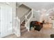 Living room with staircase, brown couch, and carpet flooring at 1968 Drennon Ave, Austell, GA 30106