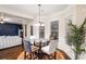 Bright breakfast nook with a glass-top table and view of living room at 1077 Sly Fox Run, Fairburn, GA 30213