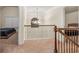 Upstairs hallway with views into bedrooms and chandelier at 1077 Sly Fox Run, Fairburn, GA 30213