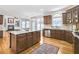 This open kitchen features granite countertops, stainless appliances, and hardwood floors at 198 Grandmar Chase, Canton, GA 30115