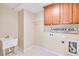 Functional laundry room features overhead cabinets, utility sink, and decorative signage at 198 Grandmar Chase, Canton, GA 30115