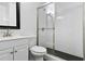 Clean bathroom with white tile, shower, and vanity at 6630 Ramsgate Way, Norcross, GA 30093