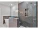 Modern bathroom features a glass shower with gray herringbone tile and built-in shelving niche at 206 Grady Burrell Dr, Holly Springs, GA 30115