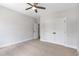 Bright bedroom with neutral walls, carpeting, ceiling fan, closet and a window at 206 Grady Burrell Dr, Holly Springs, GA 30115