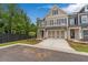 Two story townhome with attached two car garage, landscaped yard and modern exterior finishes at 206 Grady Burrell Dr, Holly Springs, GA 30115