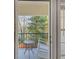 Private balcony overlooking a wooded area with a rocking chair at 3275 Lenox Ne Rd # 206, Atlanta, GA 30324