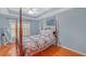 Cozy bedroom with hardwood floors and a wooden bed frame at 3275 Lenox Ne Rd # 206, Atlanta, GA 30324