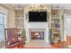 Living room fireplace with built-in shelving and hardwood floors at 3275 Lenox Ne Rd # 206, Atlanta, GA 30324