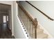 Elegant staircase with a wooden handrail and metal balusters at 4078 Annsbury Ct, Lilburn, GA 30047