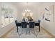 Modern dining room with dark wood table, blue velvet chairs and art at 793 River Gardens Se Dr, Atlanta, GA 30354