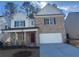 Beautiful two-story home with brick and siding exterior, a covered front porch, and an attached two-car garage at 793 River Gardens Se Dr, Atlanta, GA 30354