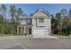 Two-story house with gray siding, white garage door, and landscaping at 820 River Gardens Se Dr, Atlanta, GA 30354