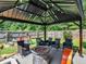 Covered patio with fire pit and seating area, perfect for outdoor entertaining at 10 Toscanno Dr, Covington, GA 30014