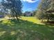 Large grassy backyard with a house visible in the distance at 230 Farm St, Hiram, GA 30141