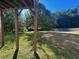 Partially fenced backyard with mature trees at 230 Farm St, Hiram, GA 30141