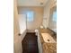 Bathroom with granite countertop, white sink, and a bathtub at 230 Farm St, Hiram, GA 30141