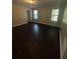 Spacious bedroom with dark hardwood floors and two windows at 230 Farm St, Hiram, GA 30141