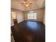 Spacious bedroom with dark hardwood floors and a large window at 230 Farm St, Hiram, GA 30141