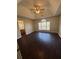 Main bedroom with dark hardwood floors, ceiling fan, and large window at 230 Farm St, Hiram, GA 30141