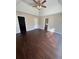 Spacious bedroom with dark hardwood floors, ceiling fan and access to bathroom at 230 Farm St, Hiram, GA 30141