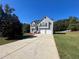 Two-story house with gray siding, attached garage, and landscaped lawn at 230 Farm St, Hiram, GA 30141