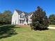 Gray siding two-story house with a manicured lawn and large tree at 230 Farm St, Hiram, GA 30141