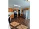 Kitchen with wood cabinets, stainless steel appliances, and dark hardwood floors at 230 Farm St, Hiram, GA 30141