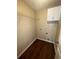 Laundry room with dark hardwood floors, shelving and cabinets at 230 Farm St, Hiram, GA 30141