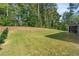 Spacious backyard with grassy area and wooded backdrop at 2570 Reynolds Sw Rd, Atlanta, GA 30331